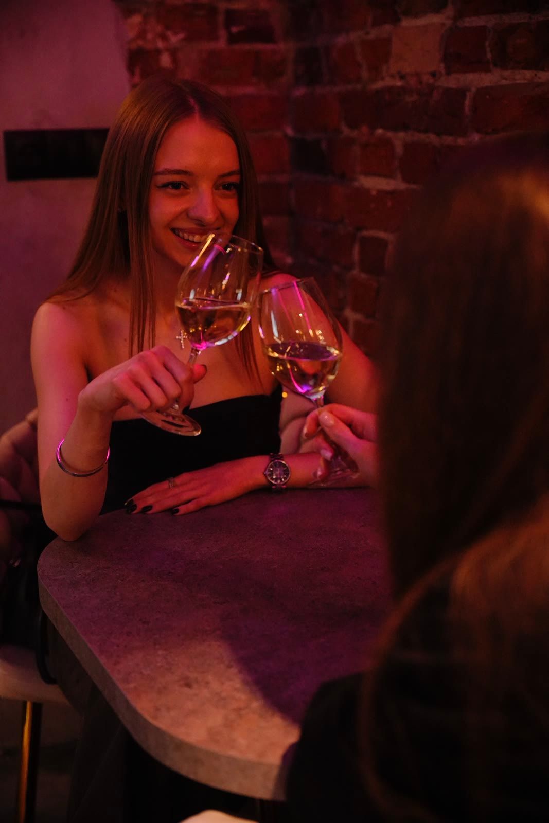 Goście z kieliszkami wina w lounge